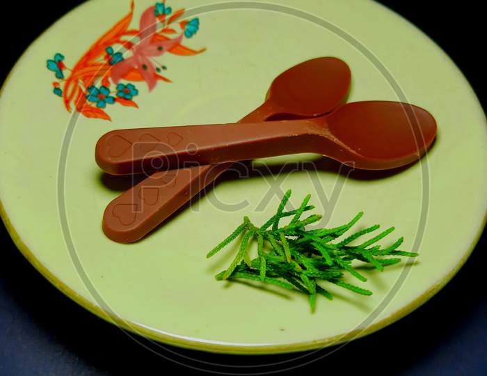 Chocolate Candy Spoons On Glass Design Plate
