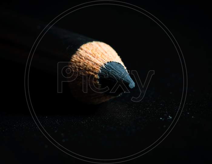 A Macro Shot Of A Black Pencil Tip. Kept In A Dark Background