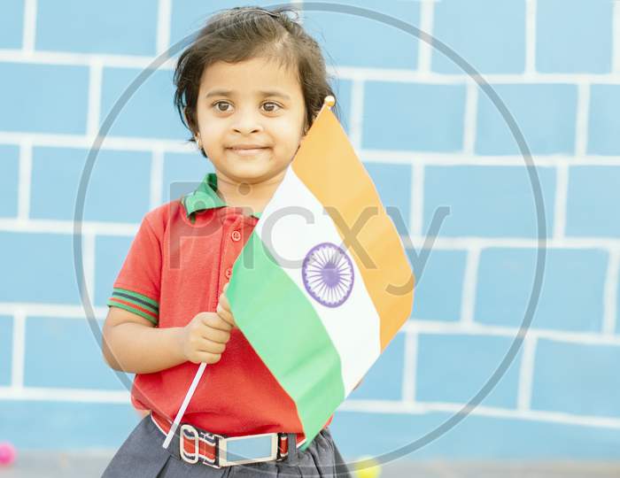 A Kindergarten Kid Waving India Flag