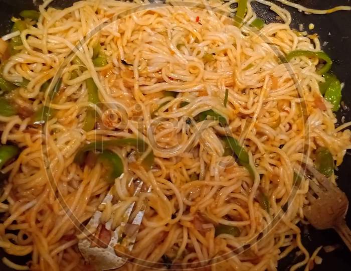 Bowl Of Noodles With Vegetables On Blue Table