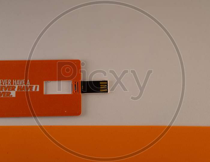 Pen drive with a smart foldable design on a white and orange background.