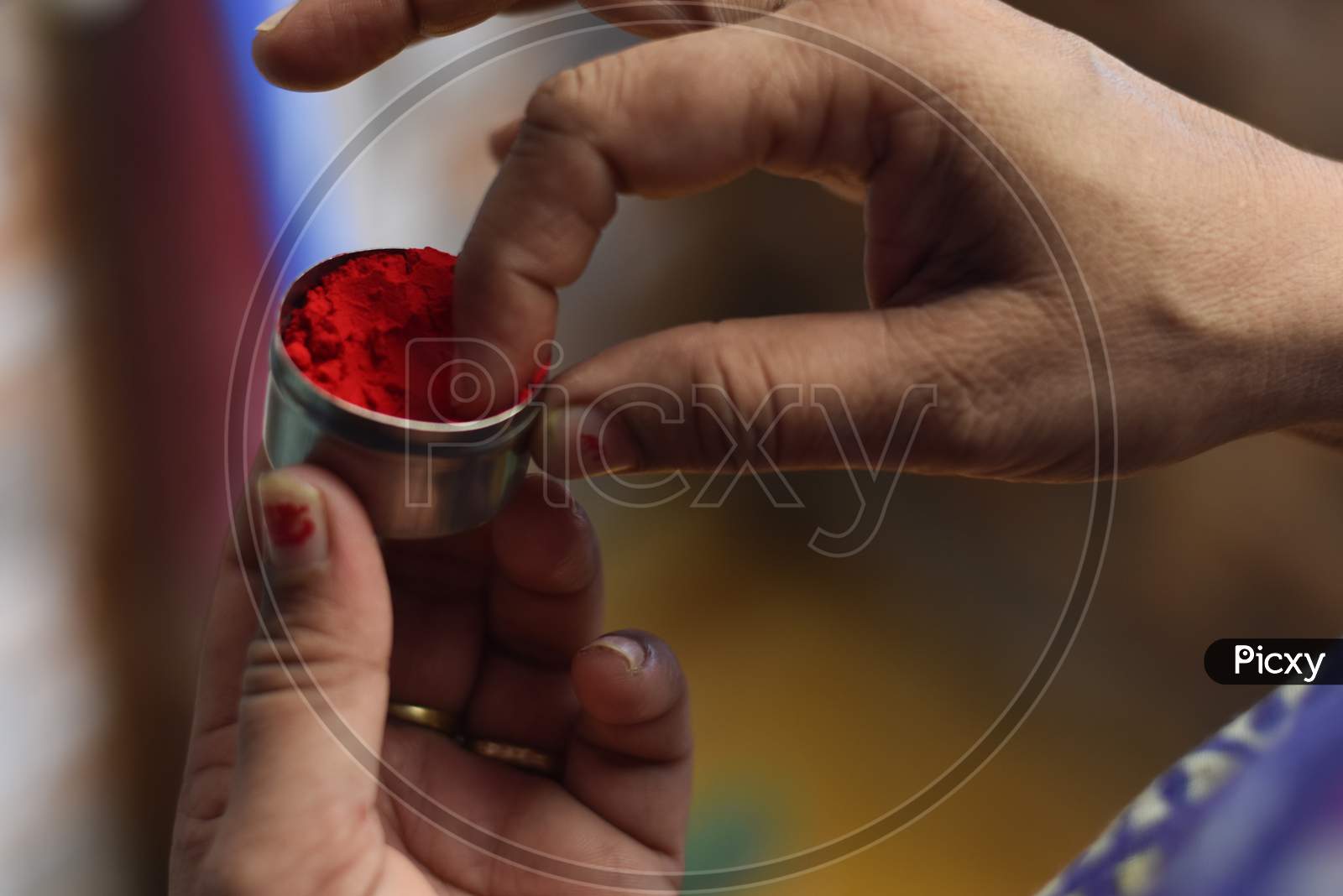 indian traditional sindoor (vermilion) box in a girl hand with shallow depth of field, Indian Culture