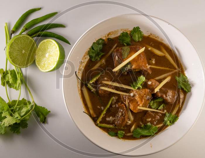 Top View of Mouth watering Beef Nihari Served with lemon, ginger, coriander and green chilli.