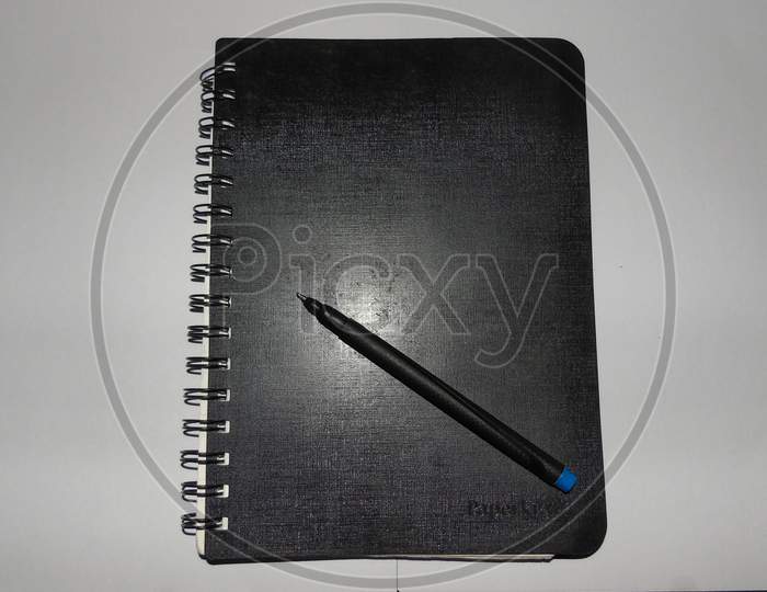 Black diary with pencil