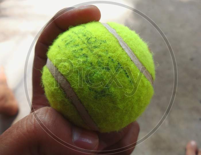 Tenis ball in human hand closeup Photography