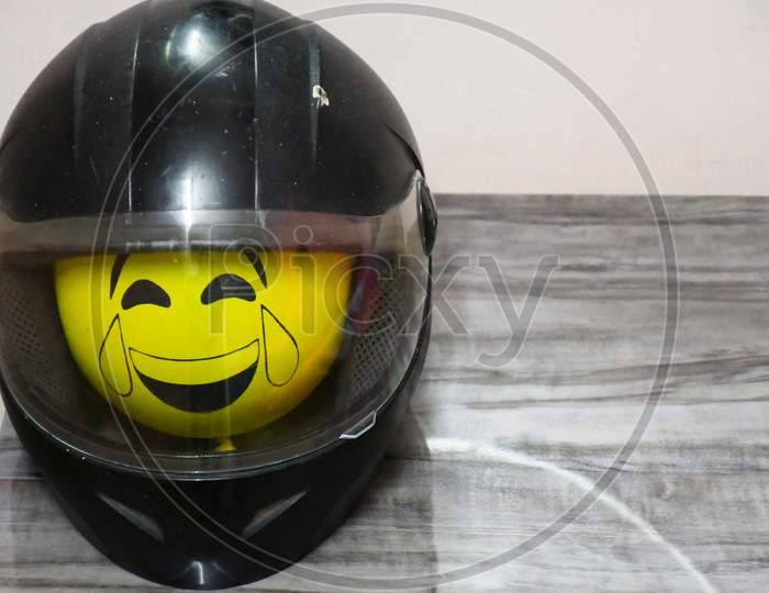 Helmet black color and Emoji Balloon in side of helmet its sow of safety