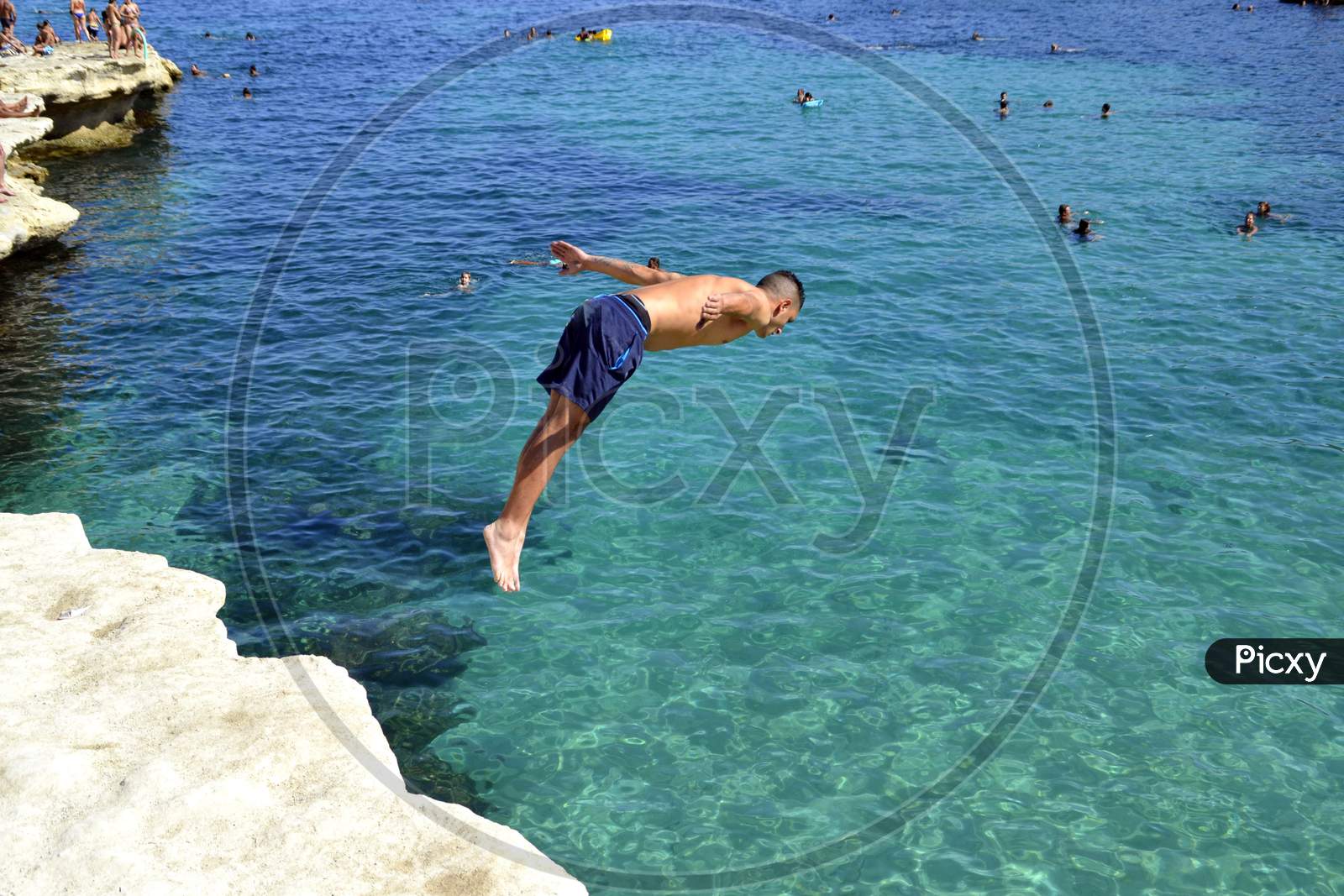 Man diving into the mediterranean sea.  Malta