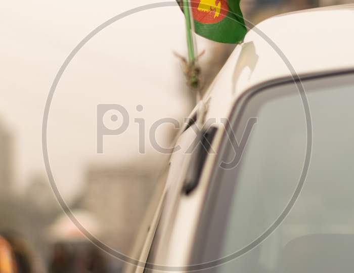 Waving Bangladeshi Flag Attached With The Radio Antenna Of A Car