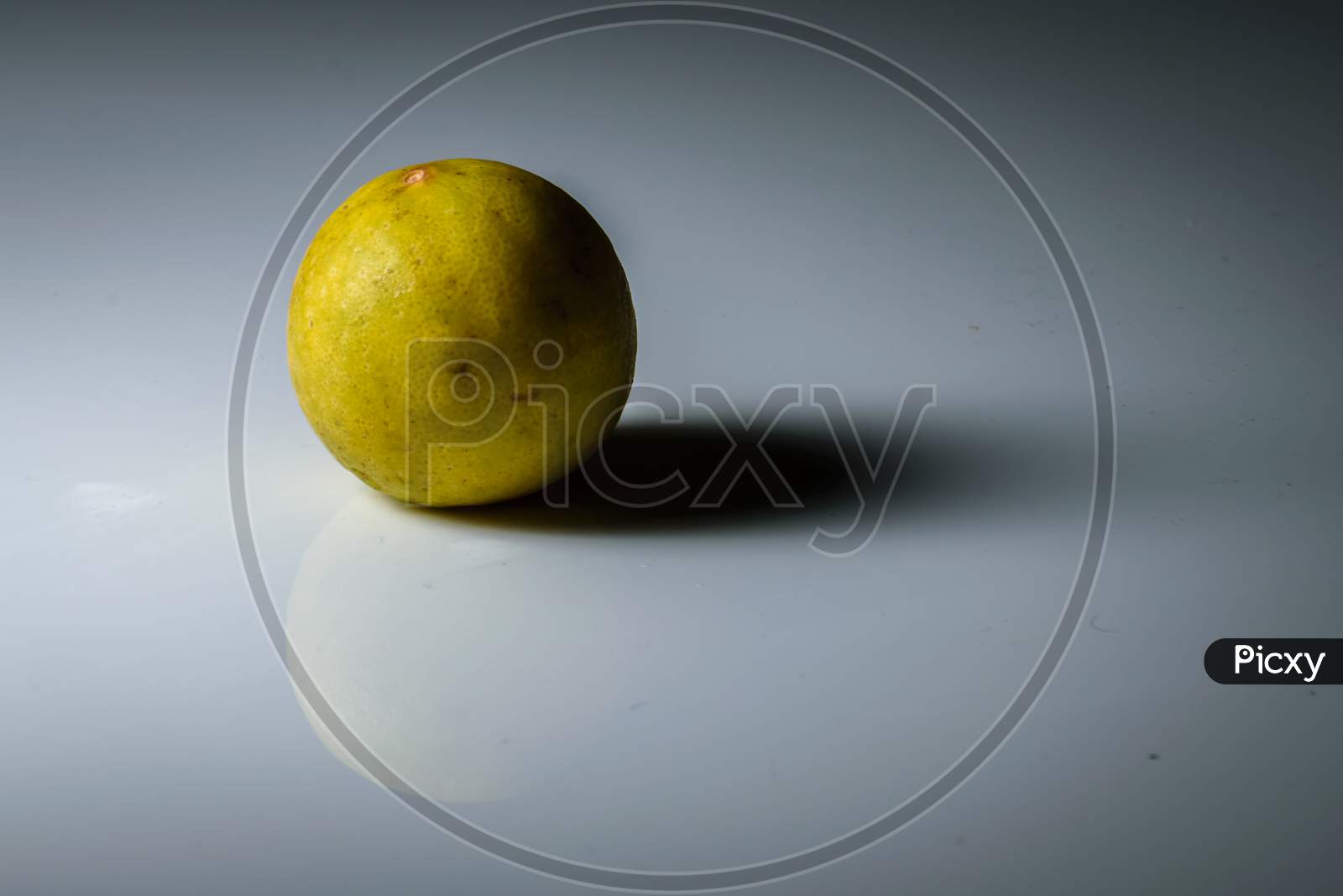 Isolated Lemon Placed In A White Background With Space For Text In The Right