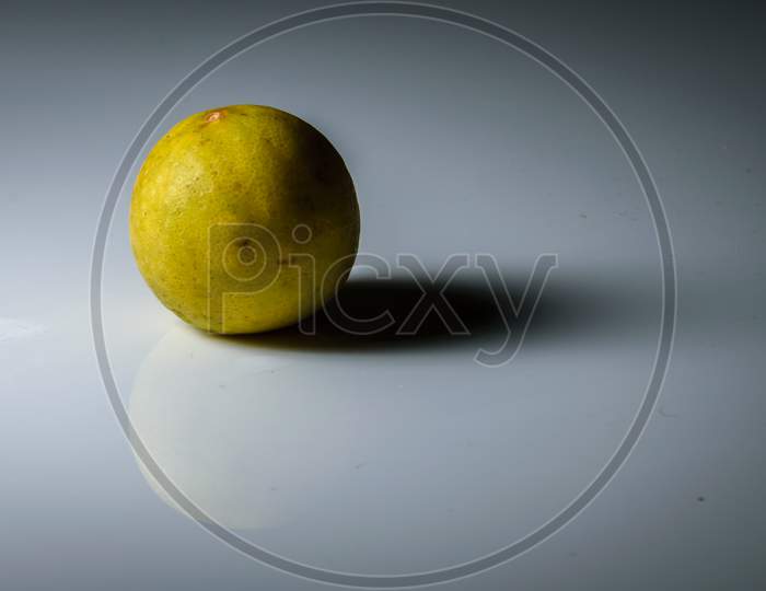 Isolated Lemon Placed In A White Background With Space For Text In The Right