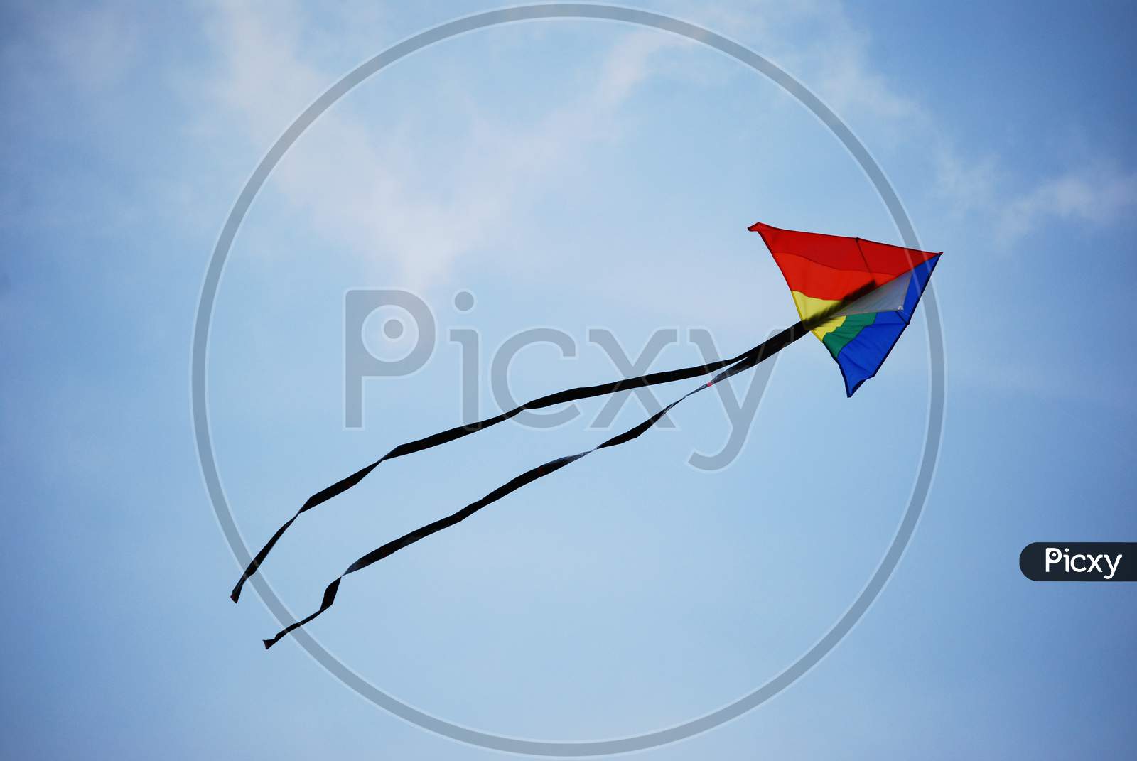 A colored kite flying high in the sky