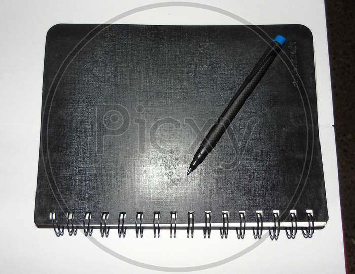 Black diary with pencil