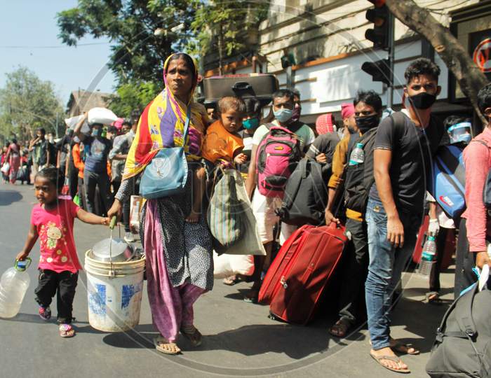 A mother walks with her kids while waiting to go to Chhatrapati Shivaji Maharaj Terminus (CSMT),  that will take them to their home state during an extended lockdown to slow the spreading of the coronavirus disease (COVID-19), in Mumbai, India, May 30, 2020.