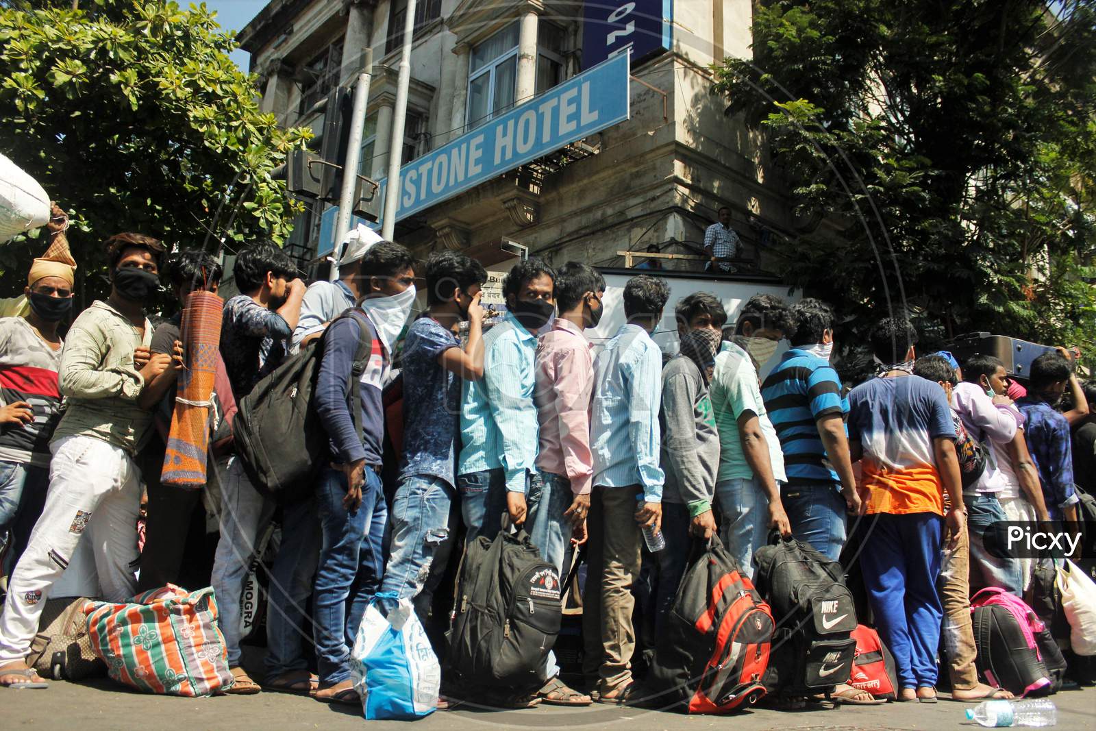 Migrants stand in a queue in huge numbers waiting to go to Chhatrapati Shivaji Maharaj Terminus (CSMT),  that will take them to their home state during an extended lockdown to slow the spreading of the coronavirus disease (COVID-19), in Mumbai, India, May 30, 2020