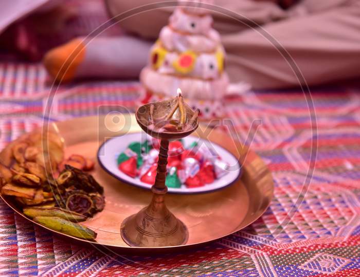 Diya kept in a plate in a rice ceremony event