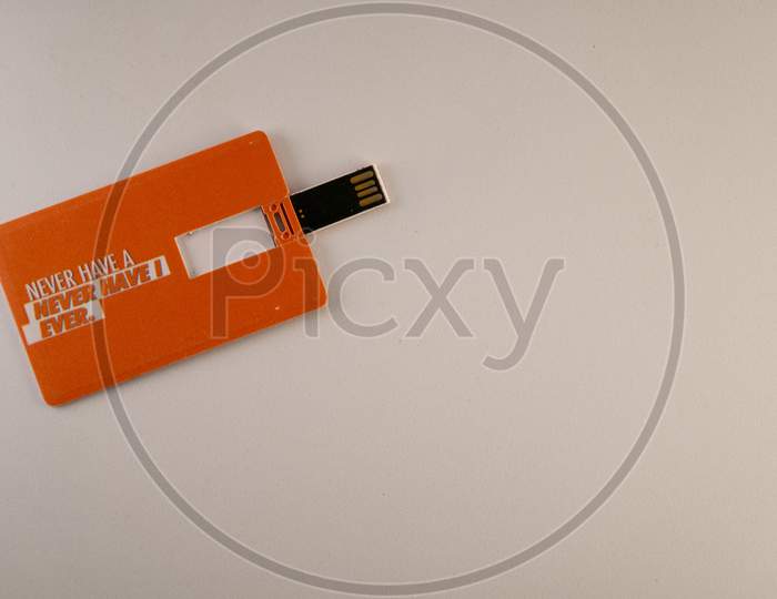 Pen drive with a smart foldable design on a white and orange background.