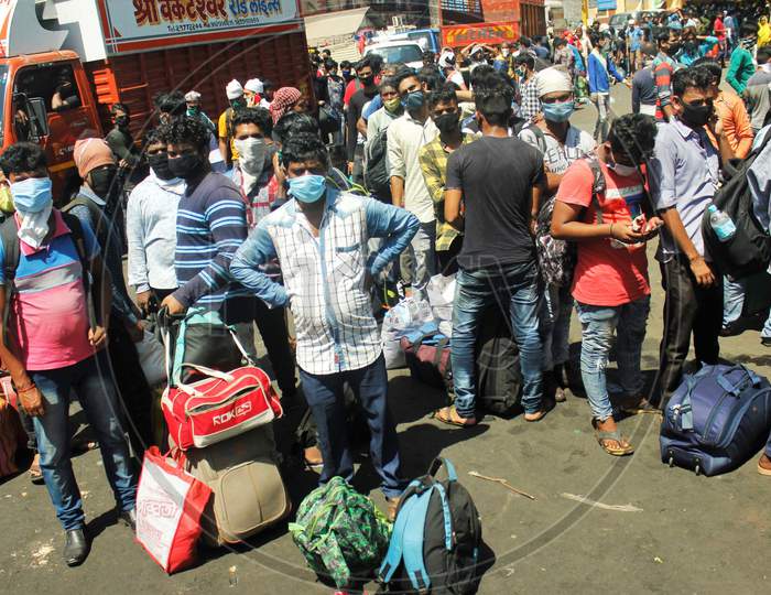 Migrants gather in huge numbers without maintaining social distance waiting to go to Chhatrapati Shivaji Maharaj Terminus (CSMT),  that will take them to their home state during an extended lockdown to slow the spreading of the coronavirus disease (COVID-19), in Mumbai, India, May 30, 2020.