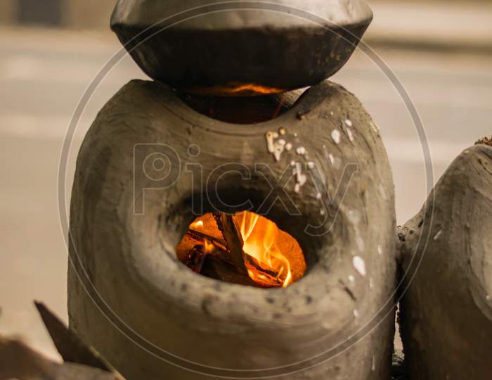 Cooking Pot On A Burning Traditional South Asian Stove Made By Soil In The Road Side Street Food Shop