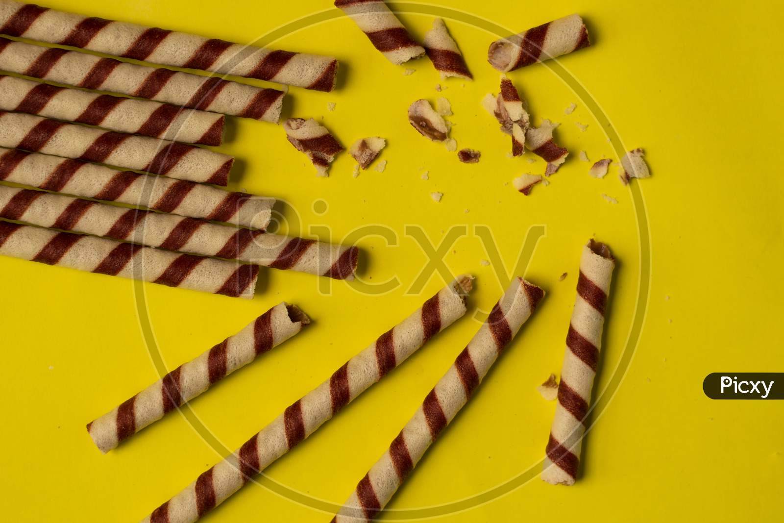 Chocolate Wafer Roll On A Plain Yellow Background