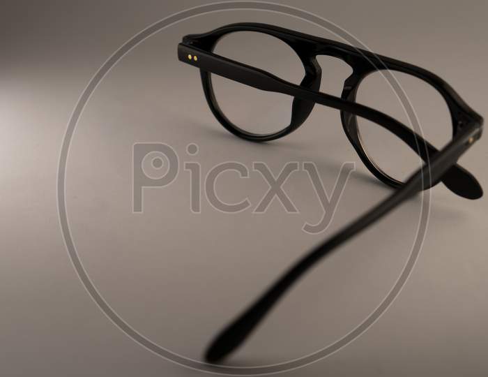 Black frame spectacle or eye glasses isolated on a white background. Photo has empty space for text.