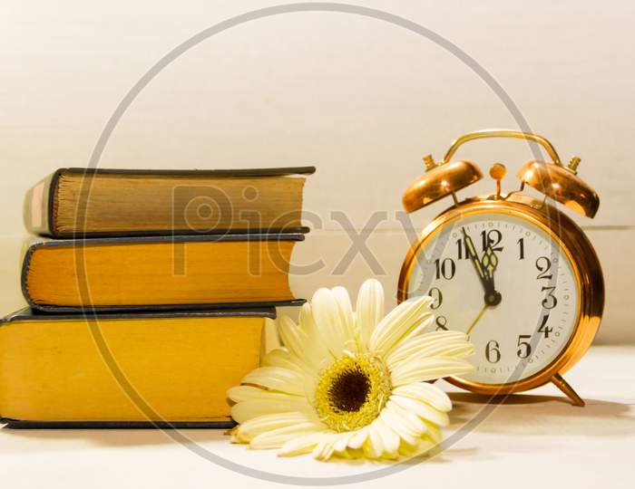 Clock Flowers And Books Concept Of Spring Time And Reading