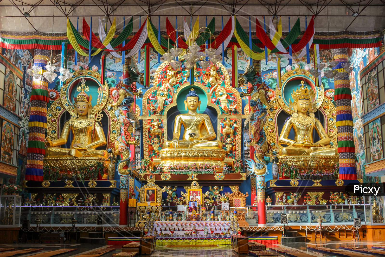 Three statues of Buddha in Golden Temple at Bylukoppe /India.
