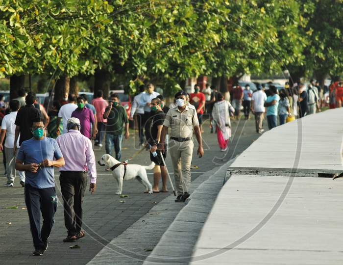 People walk along the promenade at Marine Drive after some restrictions were lifted, in Mumbai, India on June 6, 2020.