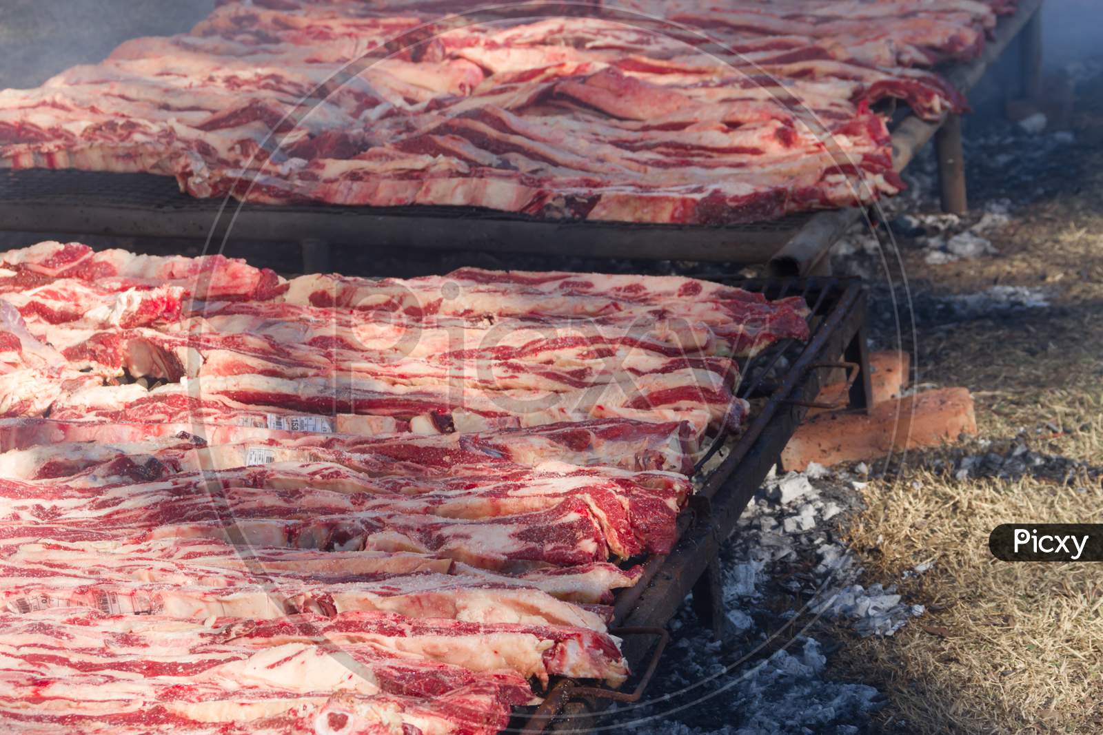 Traditional Meat Grilled On The Grill In The Argentine Countryside