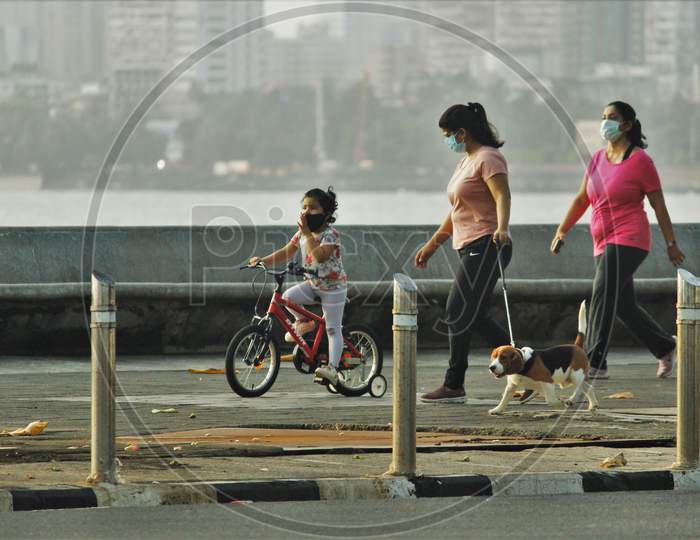 People walk along the promenade at Marine Drive after some restrictions were lifted in Mumbai, India on June 6, 2020.