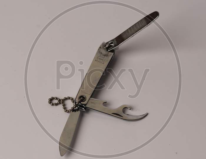 Nail cutter with a knife and bottle opener