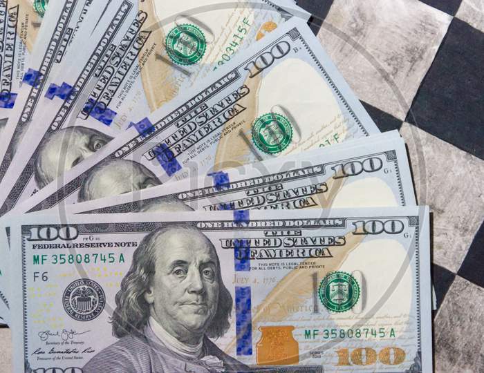 Finance Concept With Dollar Bills On Chessboard
