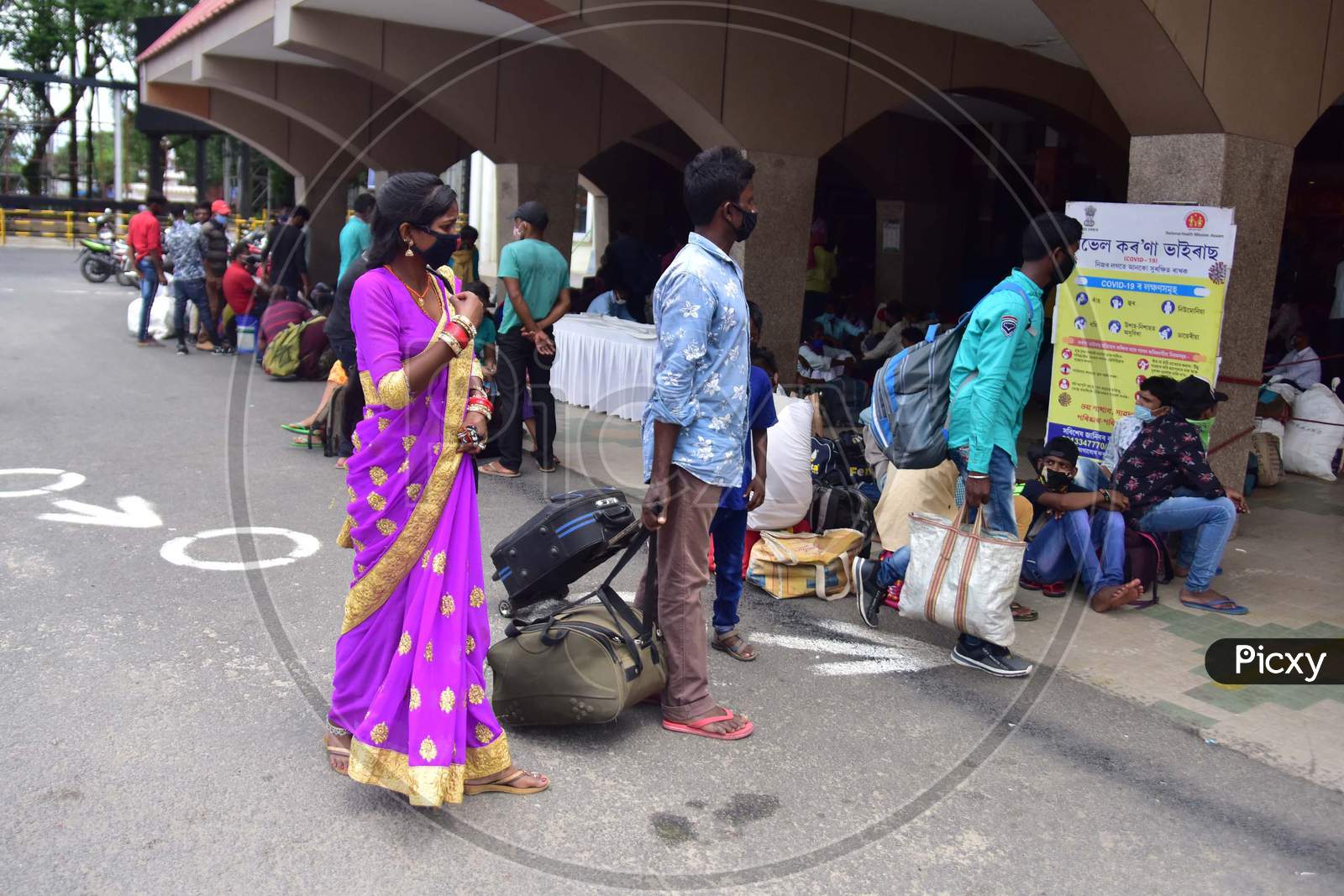 Migrant Workers And Families With Their Luggage Wait Outside The Railway Station To Board A Train, After The Government Eased A Nationwide Lockdown In Guwahati , India On June 14, 2020.
