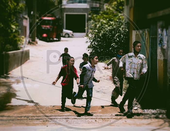 Street kids playing on roads carelessly without masks