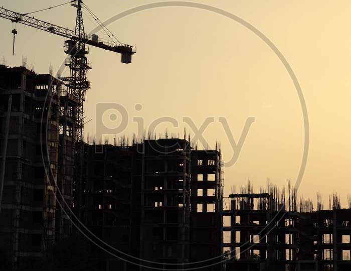 Silhouette Shot Of Buildings Under Construction With A Crane On The Top And Support Beams Clearly Visible Shot In Delhi, India