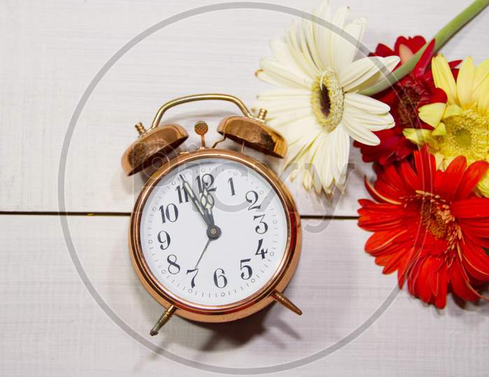 Clock Flowers And Books Concept Of Spring Time And Reading