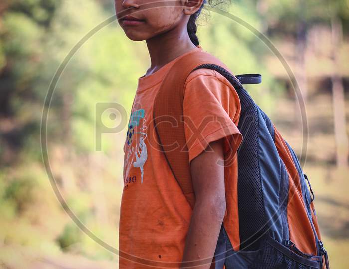 Almora, Uttrakhand/ India - June 14 2020 : A Portrait Of A Small Girl With White Marks On Her Face Going To School With A Heavy Bag.