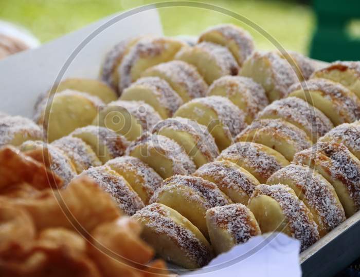 Alfajores Fried Cakes And Churros For Sale At The Street Fair