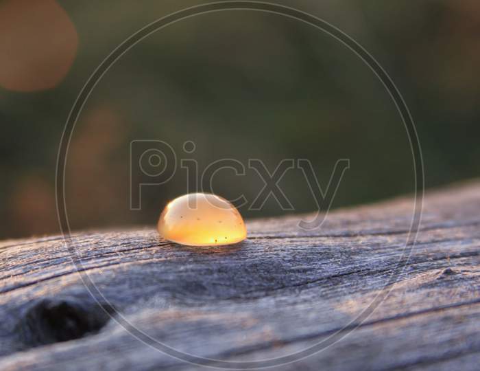 Isolated Chalcedony Agate Gemstone On Wooden Background