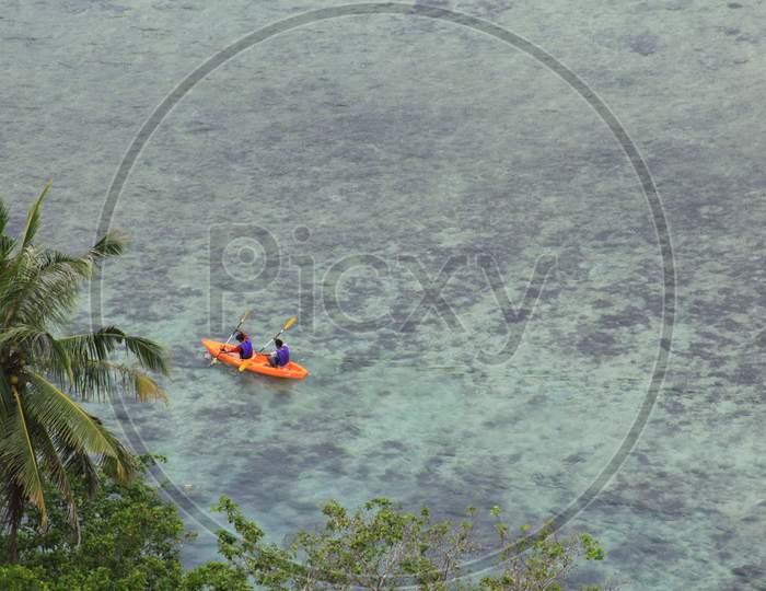 People In Sea Kayak On Island Coast Tropical Sea