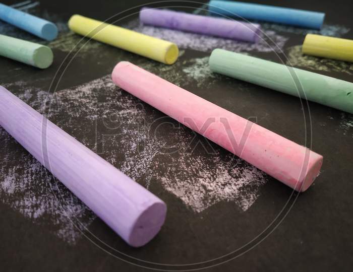 Collection of Colourful chalks on black background