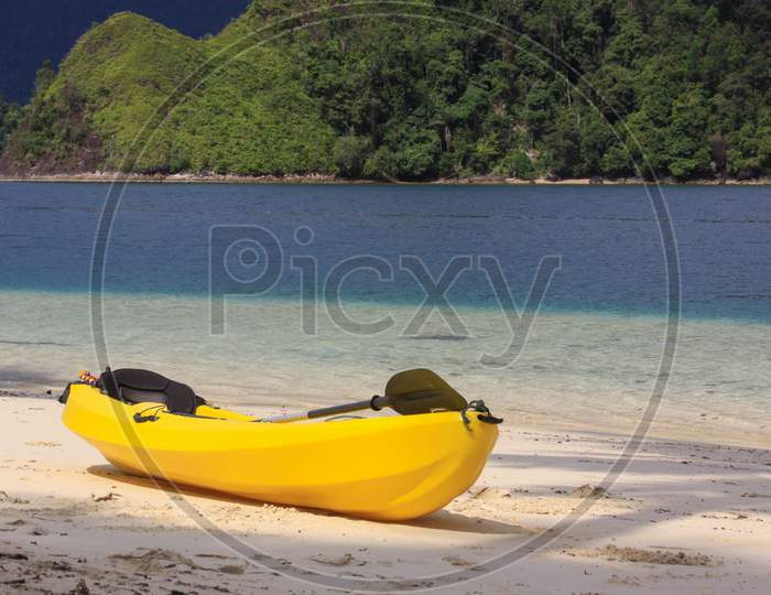 Yellow Kayak On The Beach Of Exotic Tropical Island