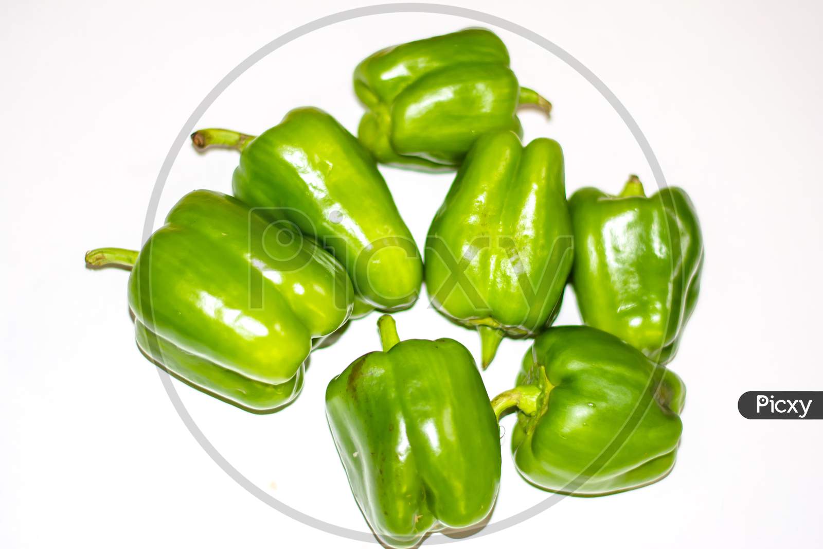 Fresh green capsicum or bell pepper isolated on a white background