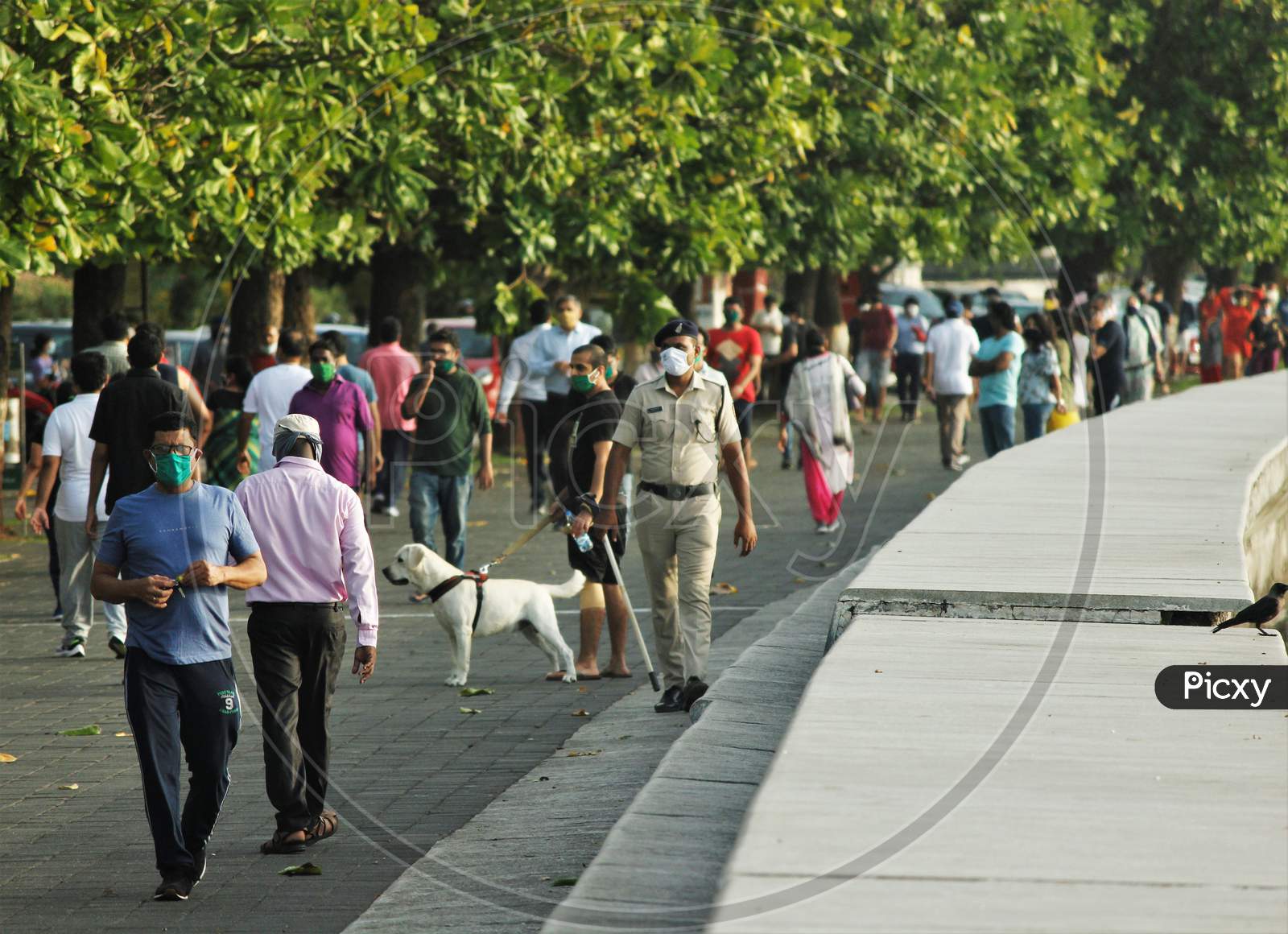 People walk along the promenade at Marine Drive after some restrictions were lifted, in Mumbai, India on June 6, 2020.