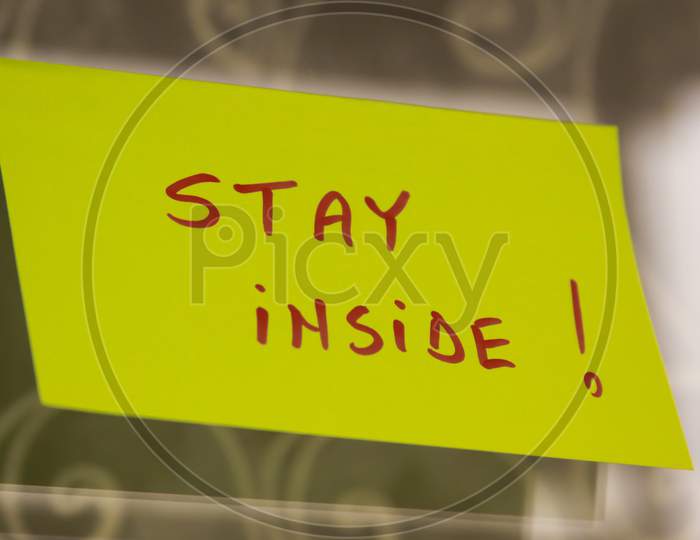 Sticky Note On Window With Stay Inside Writing Text Message
