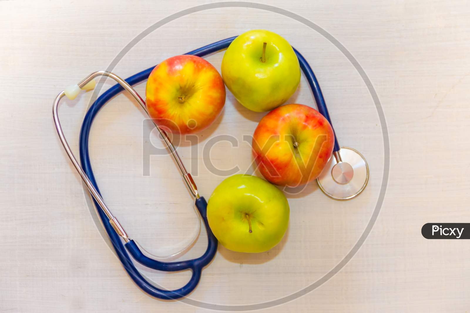 Health Concept With Green And Red Apples And Stethoscope