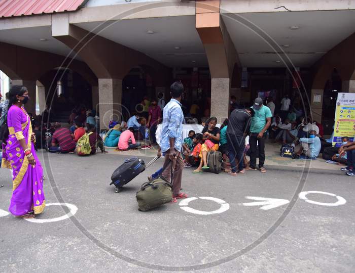 Migrant Workers And Families With Their Luggage Wait Outside The Railway Station To Board A Train, After The Government Eased A Nationwide Lockdown In Guwahati , India On June 14, 2020.