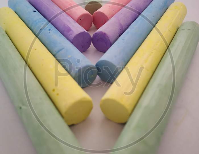 Colourful chalks on white background
