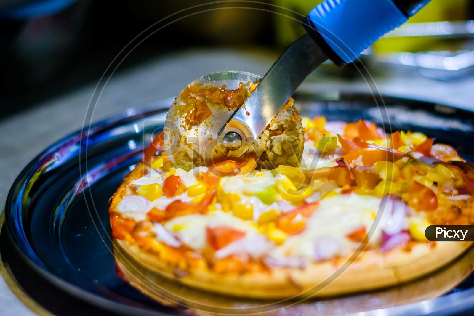 Fresh Homemade cheese pizza, with tomato, onion, corn toppings, with selective focus in lockdown.