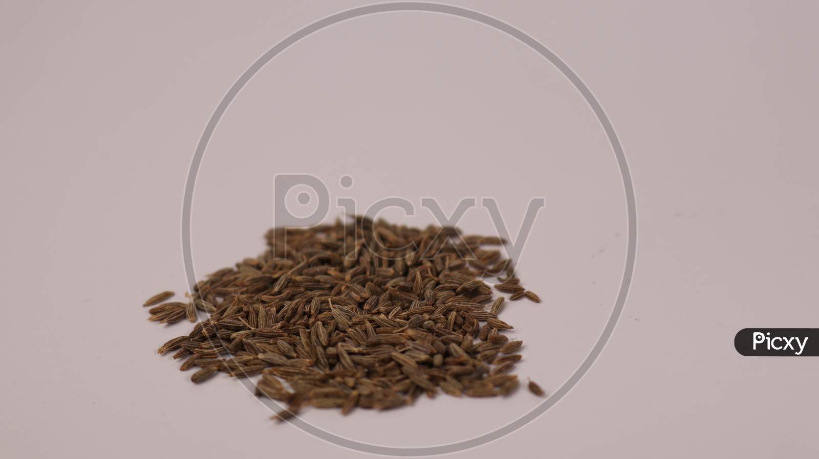 Closeup shot of cumin seeds on white background