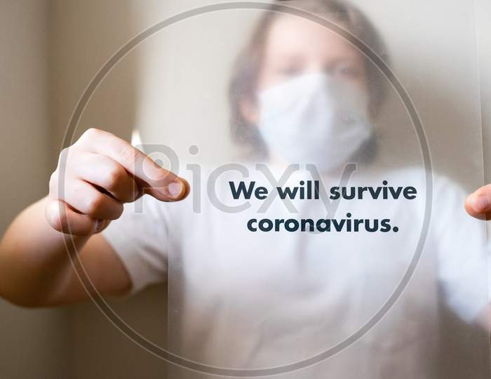 man in white crew-neck t-shirt holding a slogan on corona virus global pandemic.